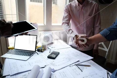 Engineer handshaking. architect shaking hands for building construction proje Stock Photos