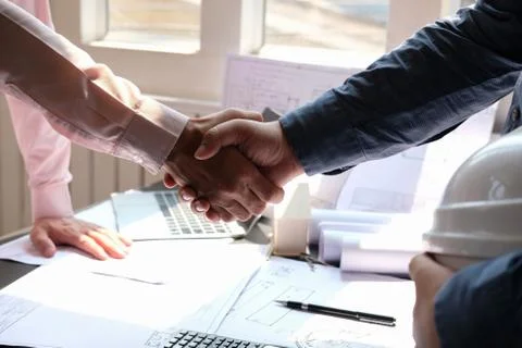 Engineer handshaking. architect shaking hands for building construction proje Stock Photos