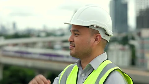 Engineer handsome man smile and proud of the work with white safety helmet. Stock Footage 164834469