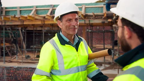 Engineer, happy man or discussion on construction site for planning, update or Stock Footage 336203875