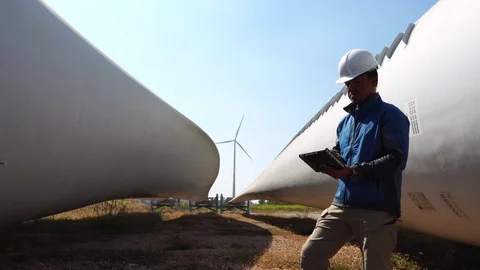 Engineer with hard hat against wind turbine  Видео 121199033