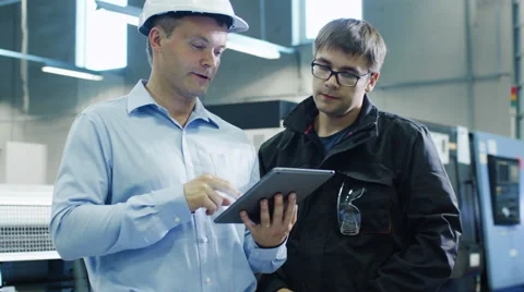 Engineer in Hard Hat and Factory Worker is Using Tablet PC 動画素材 52320592