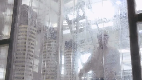 Engineer in hard hat and factory worker walking through production facility and Stock Footage 121868795