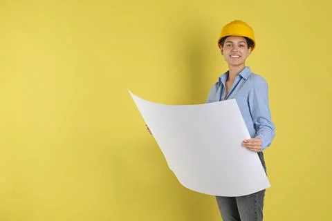 Engineer in hard hat with draft on yellow background, space for text Stock Photos