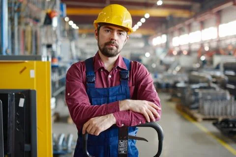 Engineer in hard hat looks at the camera. Stock Photos