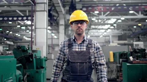 Engineer in hard hat is moving through a heavy industry factory with a tablet Stock Footage 172016551
