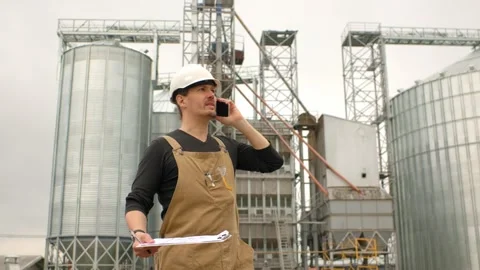 An engineer in a hard hat with a project in hand checks the construction status  Stock Footage 271629598