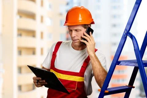Engineer in hard hat talking on phone. Stock Photos