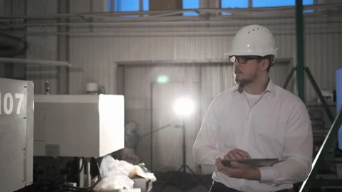 Engineer in Hard Hat is Walking Through Factory. Back View Video stock 114502867
