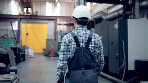 Engineer in Hard Hat is Walking Through Factory. Back View Stock Footage 171775934