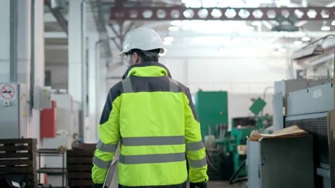 Engineer in Hard Hat is Walking Through Factory. Back View Stock Footage 171776307