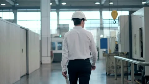 Engineer in Hard Hat is Walking Through Factory. Back View Stock Footage 171953434