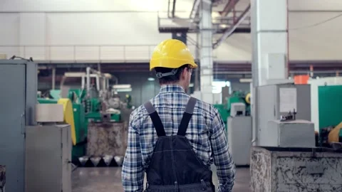 Engineer in Hard Hat is Walking Through Factory. Back View Stock Footage 172016486