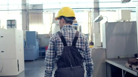 Engineer in Hard Hat is Walking Through Factory. Back View Stock Footage 172016523