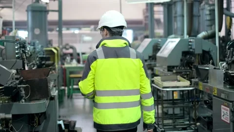 Engineer in Hard Hat is Walking Through Factory. Back View Видео 172016942