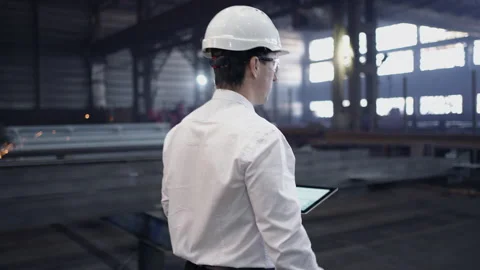 Engineer in Hard Hat is Walking Through Factory. Back View Stock Footage 237559852