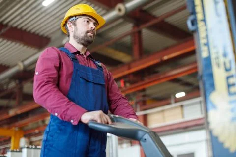 Engineer in hard hat working with mechanical equipment at the industrial plant. Foto stock