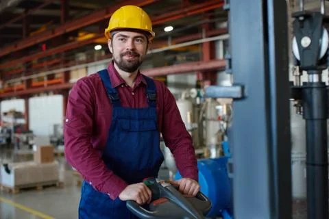 Engineer in hard hat working with mechanical equipment at the industrial plant. Stock Photos