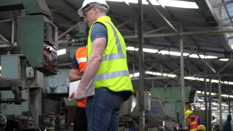 Engineer in Hard Hats and Inspector manager talking together and inspect mach Stock Footage 139820025