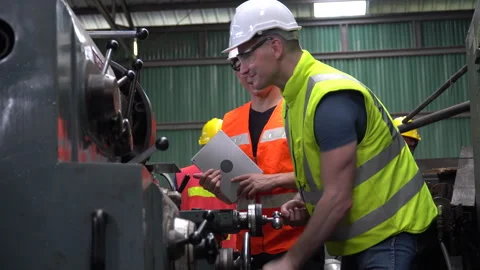Engineer in Hard Hats and Inspector manager talking together and inspect ma.. Stock Footage 246987420