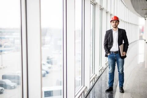 Engineer in hardhat with laptop computer, smiling at camera Stock Photos