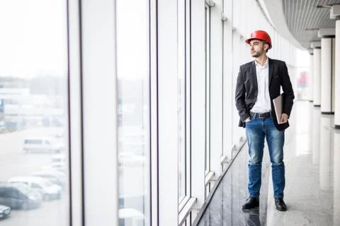 Engineer in hardhat with laptop computer, smiling at camera Stock Photos