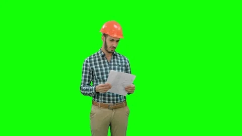 Engineer in hardhat looking at construction plan on a Green Screen, Chroma Key Stock Footage 71203936
