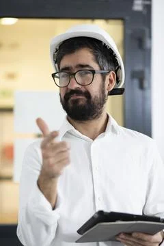 Engineer in hardhat pointing at camera Stock Photos