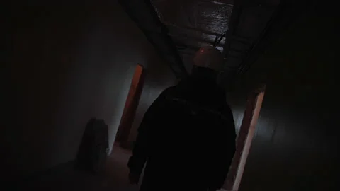 Engineer in hardhat walks along empty hallways of building Stock Footage 198784942