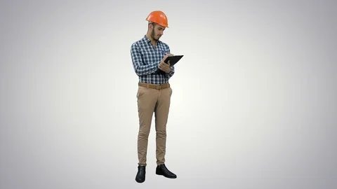 Engineer in helmet inspecting construction site on white background Stock Footage 73642641