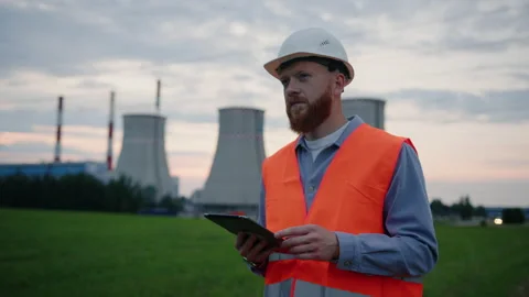 An engineer in helmet with a tablet during a check power plant Stock Footage 201669690