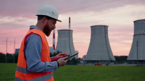 Engineer in a helmet with a tablet in his hands background of power grids Stock Footage 201669627