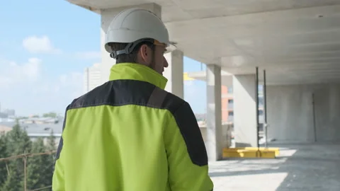 Engineer In Helmets With Tablet Device And Big Paper Drawings Discussing Video stock 113120803