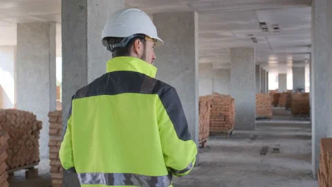 Engineer In Helmets With Tablet Device And Big Paper Drawings Discussing Stock Footage 113121391