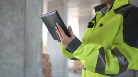 Engineer In Helmets With Tablet Device And Big Paper Drawings Discussing Stock Footage 113348744