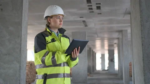 Engineer In Helmets With Tablet Device And Big Paper Drawings Discussing Stock Footage 113348874