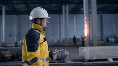 Engineer In Helmets With Tablet Device And Big Paper Drawings Discussing Stock Footage 128616682
