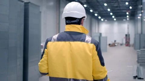 Engineer In Helmets With Tablet Device And Big Paper Drawings Discussing Stock Footage 128616917