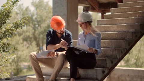 Engineer In Helmet.Two Architect Developer Inspecting Building Site Stock Footage 132517903