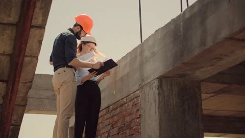 Engineer In Helmet.Two Architect Developer Inspecting Building Site Stock Footage 132517978