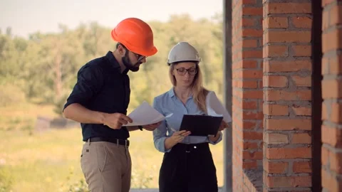 Engineer In Helmet.Two Architect Developer Inspecting Building Site Stock Footage 132518338