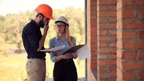 Engineer In Helmet.Two Architect Developer Inspecting Building Site Stock Footage 132518407