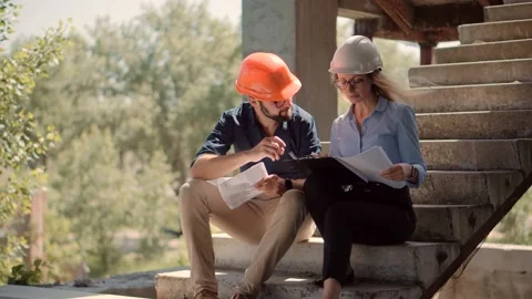 Engineer In Helmet.Two Architect Developer Inspecting Building Site Stock Footage 132518480
