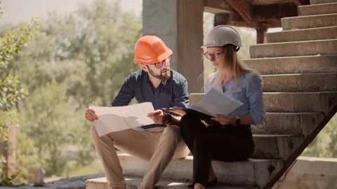 Engineer In Helmet.Two Architect Developer Inspecting Building Site Stock Footage 132518563
