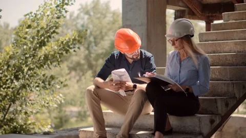 Engineer In Helmet.Two Architect Developer Inspecting Building Site Stock Footage 132518574
