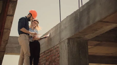 Engineer In Helmet.Two Architect Developer Inspecting Building Site Stock Footage 132518655
