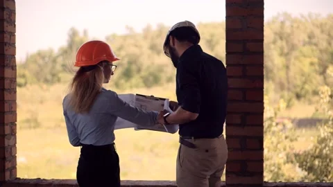 Engineer In Helmet.Two Architect Developer Inspecting Building Site Stock Footage 133216036