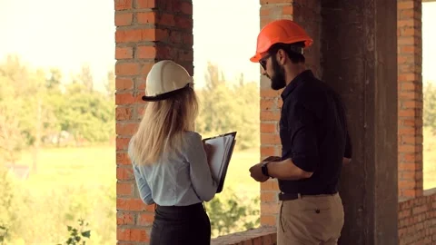 Engineer In Helmet.Two Architect Developer Inspecting Building Site Stock Footage 133216053