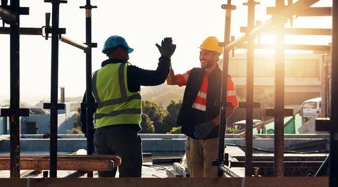 Engineer, high five and men at construction site for welcome, funny or agre.. Stock Photos