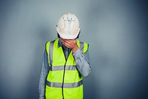Engineer in high vis covering face Stock Photos